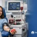 Woman donating blood using advanced medical device in modern laboratory setting for community blood bank