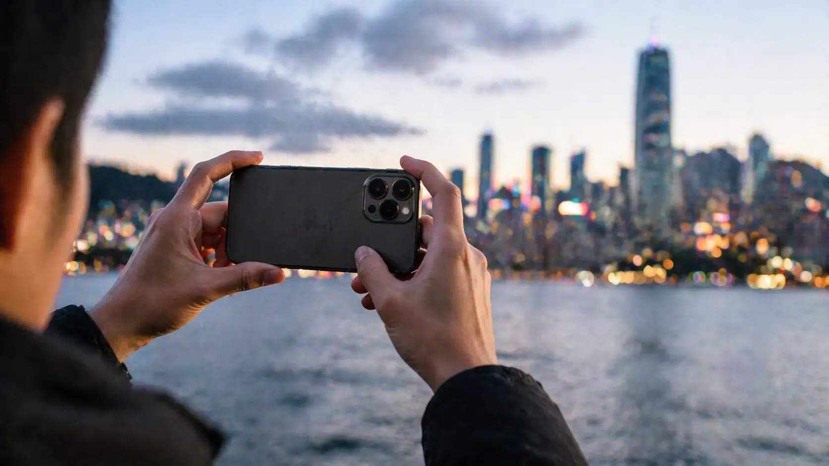smartphone capturing city skyline at dusk demonstrating telephoto zoom and low-light performance